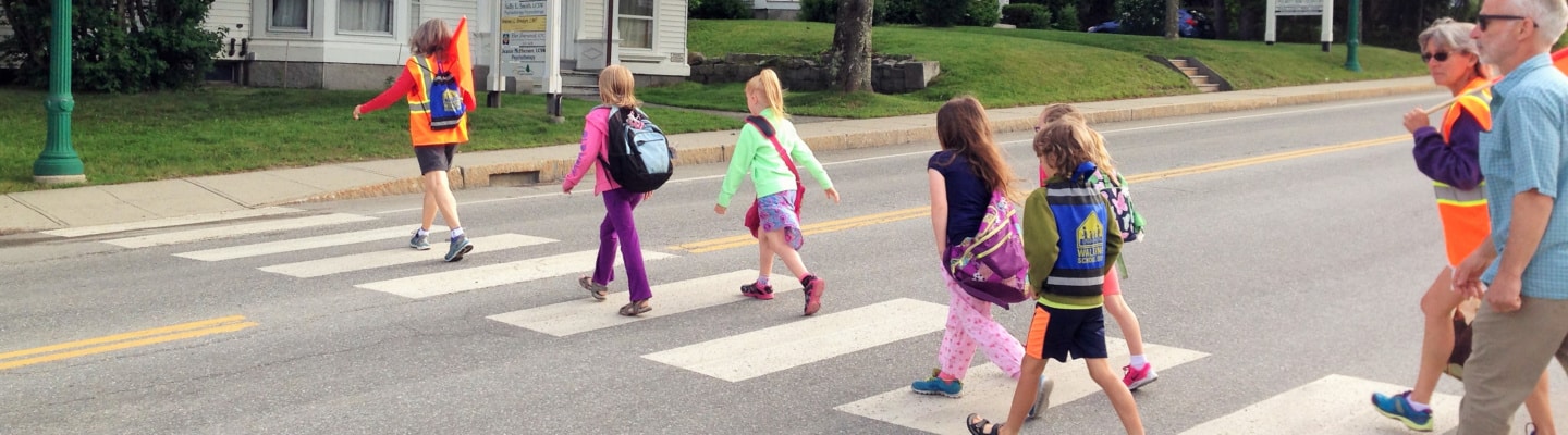 Kids crossing the street in a crosswalk
