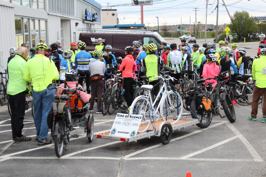 People with bikes gather for dedication ceremony before a group ride. 