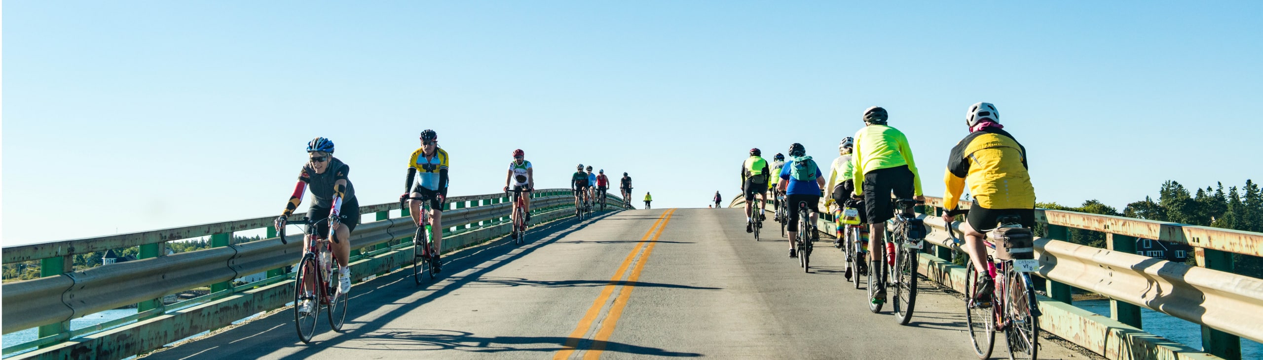 bike riders on a bridge